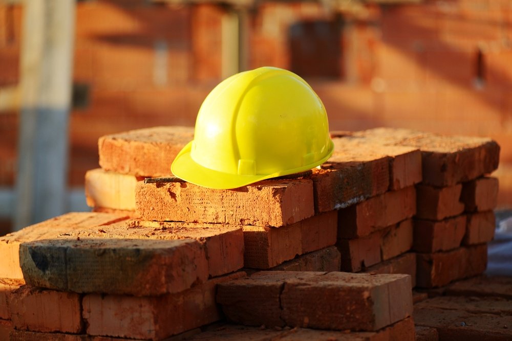 Under construction helmet and bricks for building site